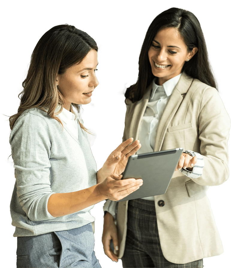 two businesswomen discussing revenue cycle optimization and EHR implementation solutions