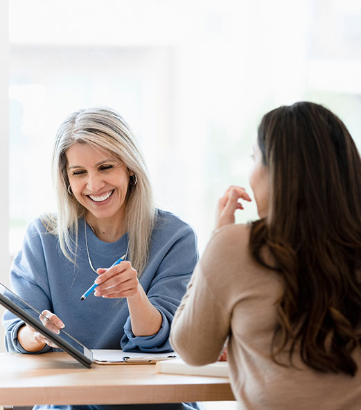 Two happy women discussing healthcare data and insights