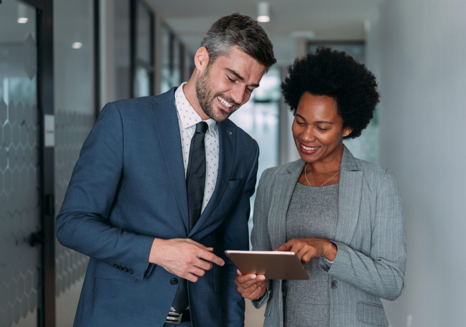 Businessman and Businesswoman, Looking at Tablet, Computer, Revenue Cycle Management