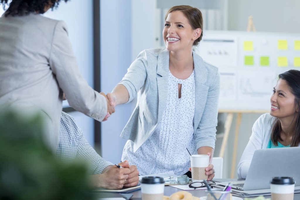 happy healthcare executive after revenue cycle management services were implemented for her health system