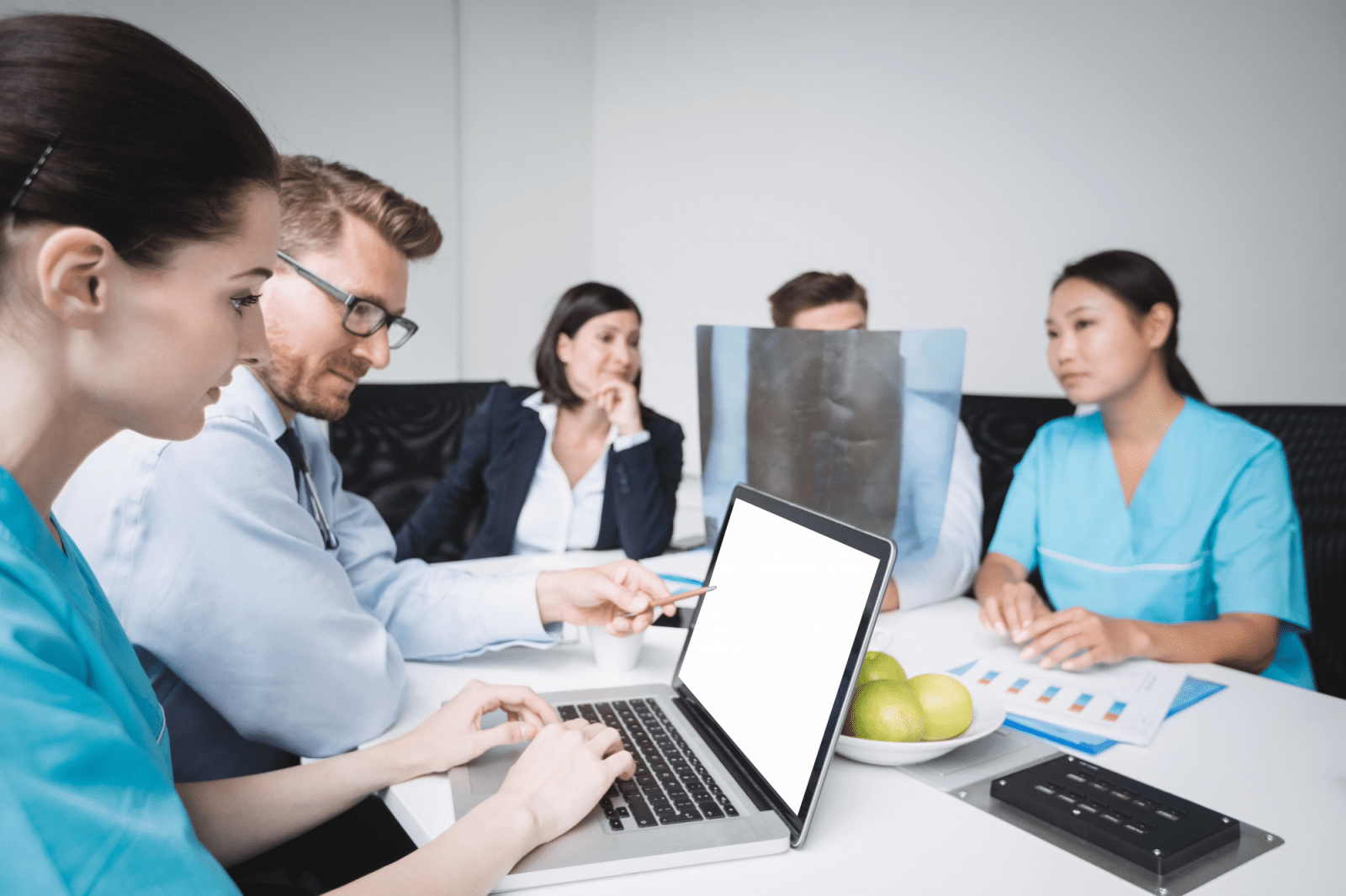 Businessman and hospital staff discussing healthcare data and analytics