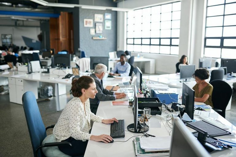 business office with people on computers, employee productivity