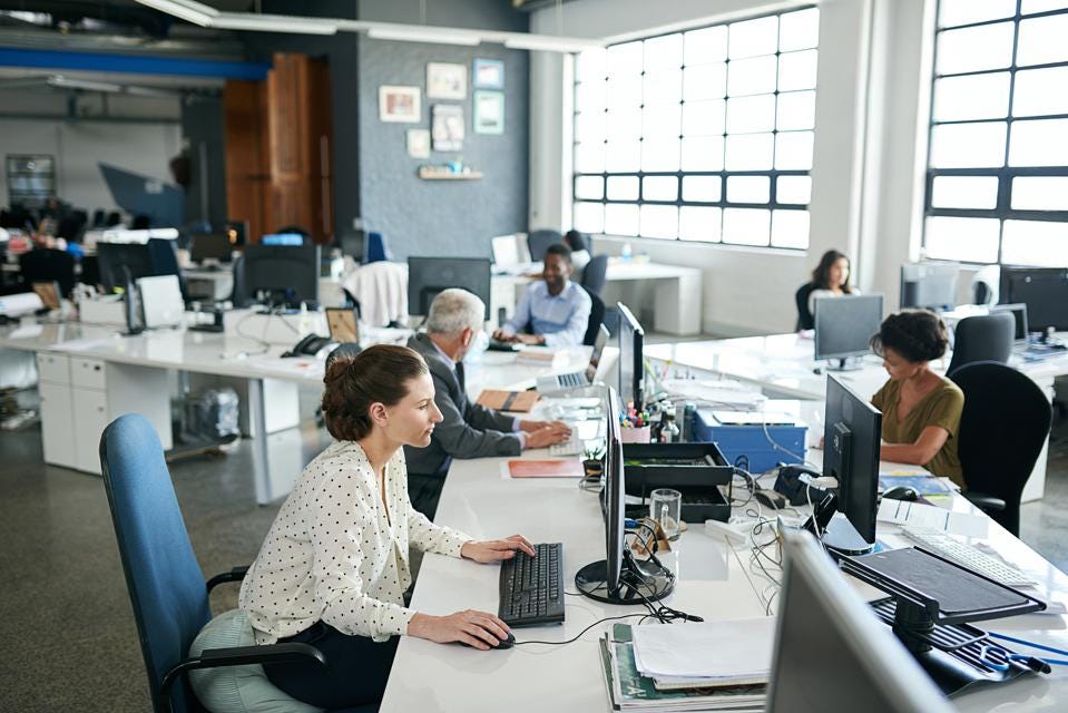 business office with people on computers, employee productivity