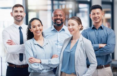 Shot of a group of businesspeople standing with their arms crossed at work