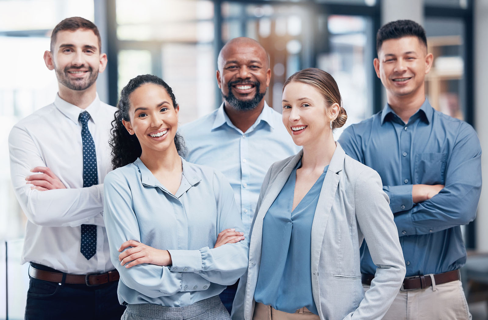 Group of business professionals posing together to represent teamwork and collaboration.