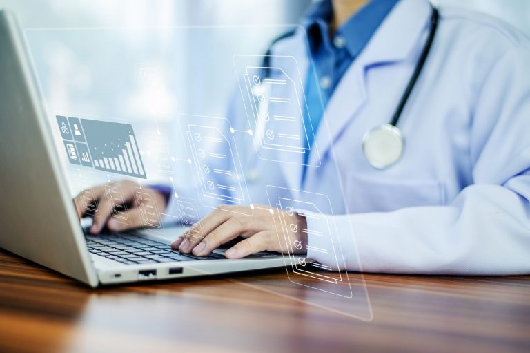 Medical Records. Doctor typing on computer.